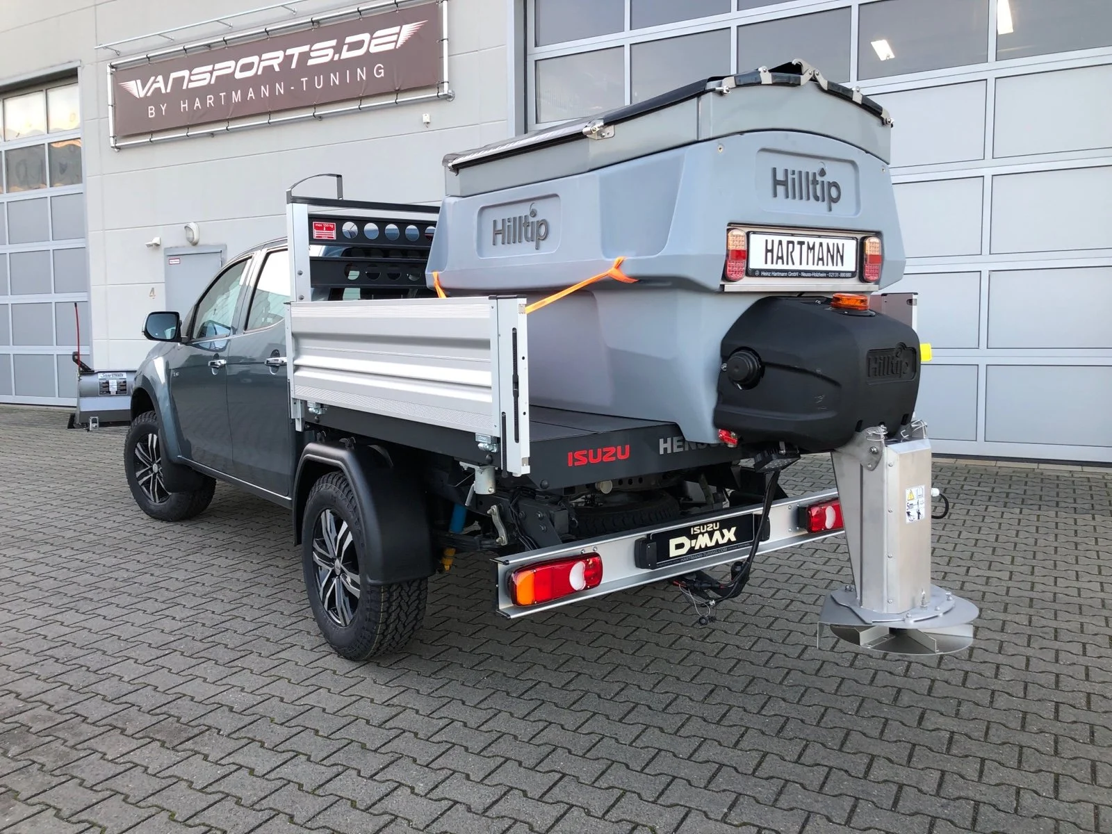 Isuzu D-Max mit Aluminium-Dreiseitenkipper mit Kabinenschutzgitter, Zusatzluftfederung, Bilstein Stoßdämpfer, Hilltip SnowStriker Schneepflug, Hilltip IceStriker Streuer, Quick Hitch Anbausystem, Lichtträger mit LED-Arbeitsscheinwerfern, Hilltip Bedieneinheit mit Joystick